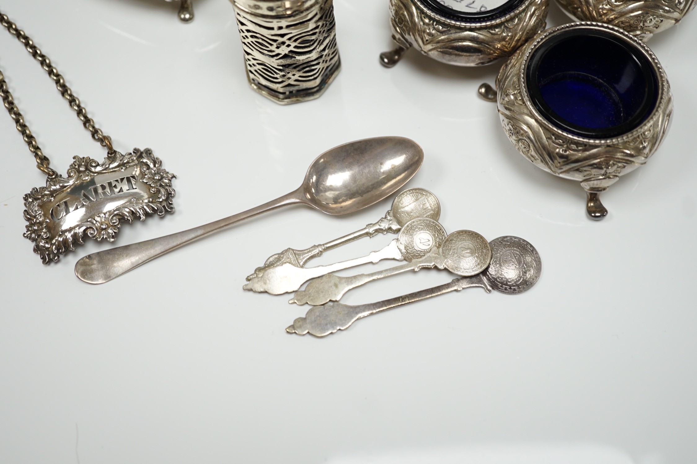 A mixed group of assorted small silver including a sugar caster, two pairs of Victorian bun salts, mustard pot, salt, pepperette, spoon and four white metal spoons.